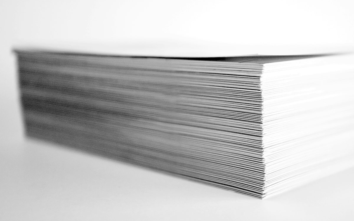 A tall stack of blank printer paper, seen from the side.